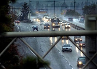 
Traffic heads through downtown Spokane on the I-90 viaduct in the rain Friday. The state will spend two summers and $15 million to repair the 1.17-mile stretch.  
 (Christopher Anderson/ / The Spokesman-Review)