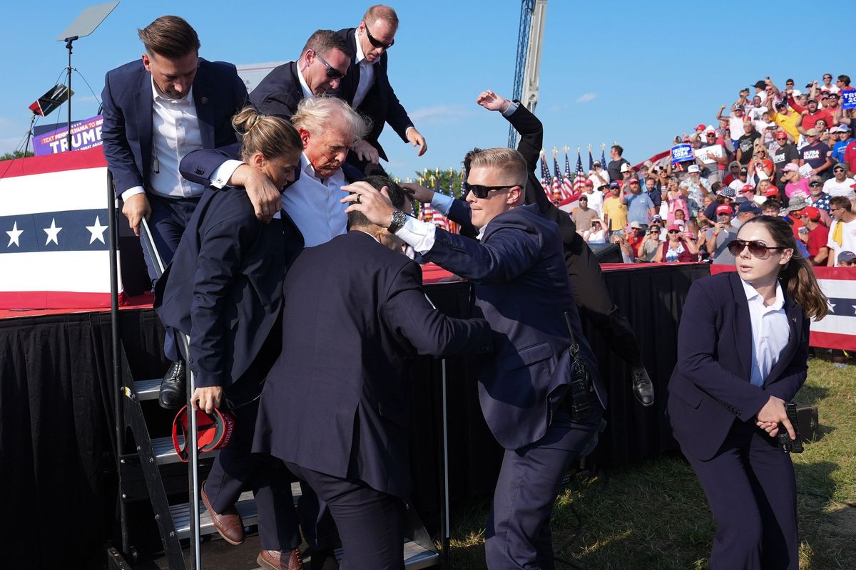 Presidential candidate Donald Trump is rushed offstage after being wounded on July 13, 2024, in Butler, Penn. (Jabin Botsford/The Washington Post)