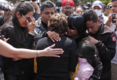 Relatives of one  of seven police officers killed Monday react  at a funeral service in Tijuana, Mexico, on Thursday. The  officers were assassinated in  what authorities said  was a coordinated effort.  (Associated Press / The Spokesman-Review)