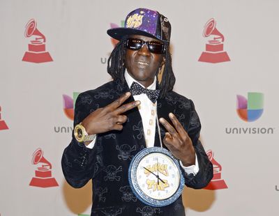 This Nov. 20, 2014, file photo shows rapper Flavor Flav, whose real name is William Jonathan Drayton Jr., at the 15th annual Latin Grammy Awards in Las Vegas. Police in Las Vegas say Ugandi Howard, 44, is facing a misdemeanor battery charge for allegedly attacking the entertainer at a local casino. Howard was issued a summons to appear March 6 in Las Vegas Justice Court. (Powers Imagery / Powers Imagery/Invision/AP)