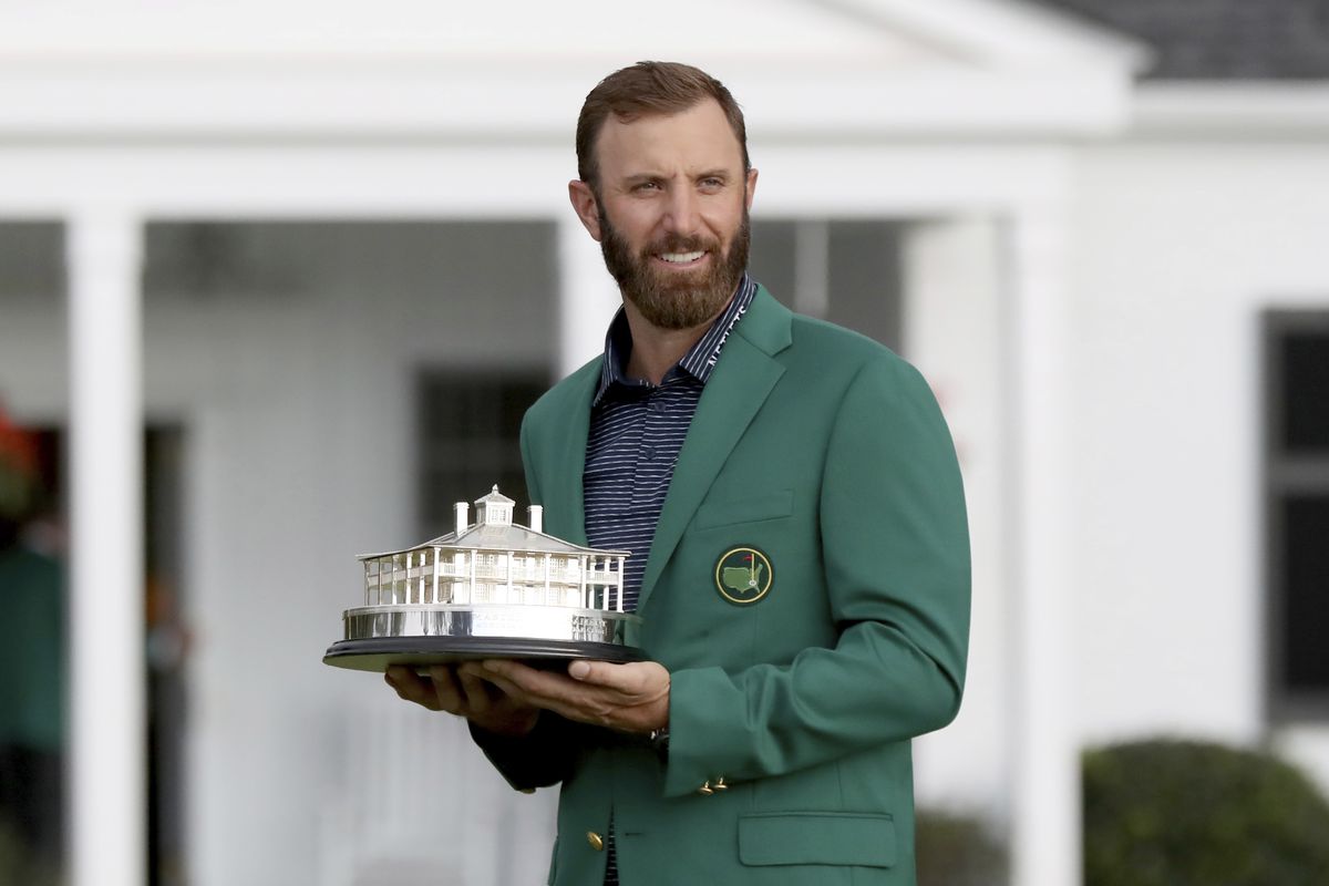 Dustin Johnson holds the trophy after being presented with his first green jacket after winning the Masters golf tournament Sunday, Nov. 15, 2020, in Augusta, Ga.  (Curtis Compton)