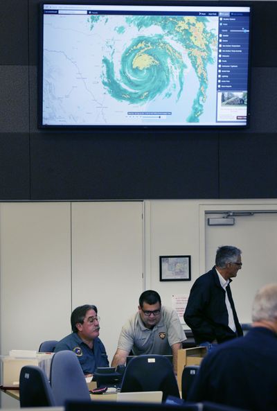 Emergency management officials monitor the situation with tropical storm Harvey at the operations center Saturday, Aug. 26, 2017, in San Antonio. A woman who gave birth to a boy during the storm named the newborn Harvey. (LM Otero / Associated Press)