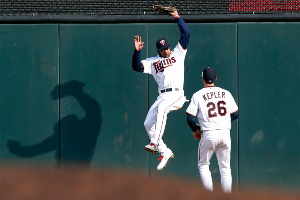 Minnesota’s Byron Buxton, left, pulls in a long fly ball off the bat of Seattle’s Mitch Haniger during the fifth inning  Thursday in Minneapolis. Looking on is right fielder Max Kepler. (Jim Mone / AP)