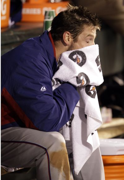 Texas Rangers' Cliff Lee wipes his face in the dugout after being pulled during the fifth inning of Game 1 of the World Series against the San Francisco Giants.  (David Phillip / Associated Press)