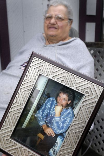 In this 2008 photo, Inez Williams sits with a photo of her son Terry Palm on the front porch of her Beacon Hill area home as she reflects on the murder of Palm and Angela Walsh. The double murder of December 2002 remains unsolved. Williams was killed Friday in a fire at her home. (Christopher Anderson / The Spokesman-Review)