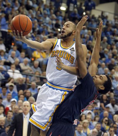 UCLA's Jerime Anderson, left, goes hard to the bucket as Arizona's Jordin Mayes attempts to defend. (Associated Press)