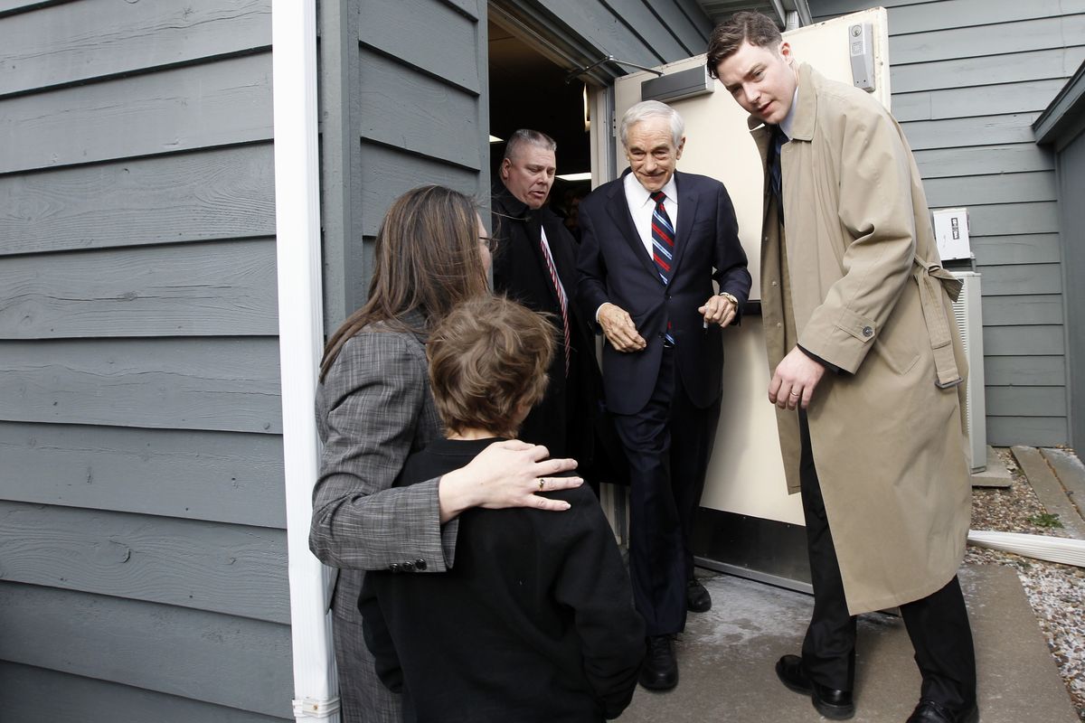 Republican presidential candidate Rep. Ron Paul, R-Texas, is greeted by supporters as he leaves a campaign rally at the Steeple Gate Inn in Davenport, Iowa, Monday. (AP/Charles Dharapak)