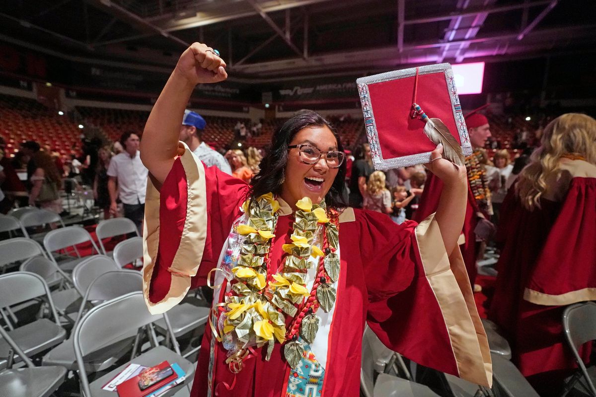 Amryn Tom reacts after graduating from Cedar City High School on Wednesday, May 25, 2022, in Cedar City, Utah. Tom is wearing an eagle feather given to her by her mother and a cap that a family friend beaded.  (Rick Bowmer)