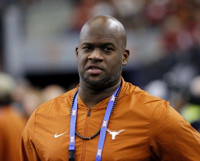 In this Dec. 1, 2018, file photo, former Texas NCAA college football quarterback Vince Young stands on the sideline during the first half of the NCAA Big 12 Conference championship against Oklahoma, in Arlington, Texas. Texas has fired former star quarterback Vince Young from his part-time role as a development officer for poor performance and often being absent from work or not in touch with his supervisors. (Roger Steinman / Associated Press)