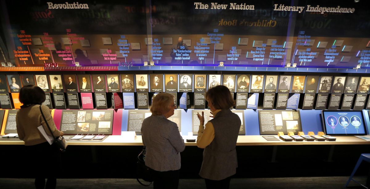 In this Monday, May 8, 2017 photo, visitors at the American Writers Museum look at a timeline display that celebrates authors who are emblematic of "American Voices", at the new museum in Chicago. (Charles Rex Arbogast / AP)