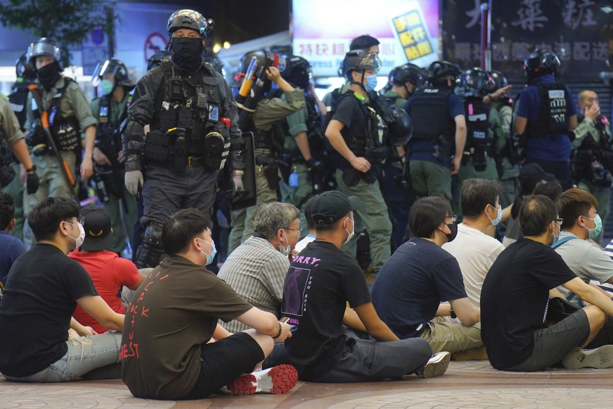 Police detain protesters against the new security law during a march marking the anniversary of the Hong Kong handover from Britain to China, Wednesday, July. 1, 2020, in Hong Kong. Hong Kong marked the 23rd anniversary of its handover to China in 1997 just one day after China enacted a national security law that cracks down on protests in the territory.  (Vincent Yu)