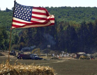 An American flag flies from a makeshift altar overlooking the investigation of the United Flight 93 crash site Sept. 16, 2001, in Shanksville, Pa. Officials announced Friday, June 1, 2018, that later in the year, the National Park Service will return the remaining wreckage of United Flight 93 to the Pennsylvania memorial marking where it crashed in the 9/11 terror attacks, and the remaining wreckage will be buried in a restricted area accessible only to loved ones of the victims. (Gene J. Puskar / Associated Press)