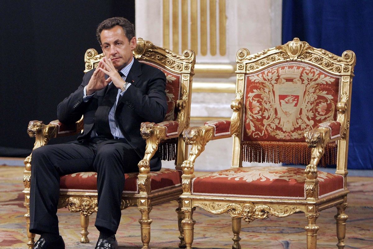 FILE - In this Thursday, May, 24, 2007 file picture, French President Nicolas Sarkozy sits during an official and traditional ceremony with Paris mayor Bertrand Delanoe, whose empty chair is at right, during which the newly elected President is met by the Paris mayor at the Paris city hall, France. The trial of former French President Nicolas Sarkozy concludes Tuesday in Paris, after a month during which the court sought to determine whether he broke laws on campaign financing in his unsuccessful 2012 re-election bid  (Christophe Ena)