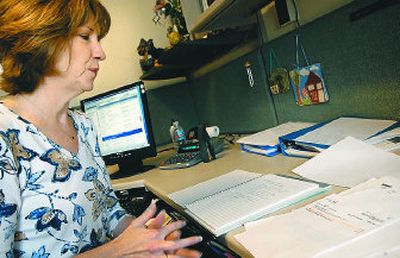 
Spokane County budget analyst Margaret Smith  talks  Thursday afternoon about finding that some people who live outside the city were being charged a municipal tax by the phone company. Qwest will credit 24 months' worth of the tax to 11,700 customers for a total of $43,000. 
 (Holly Pickett / The Spokesman-Review)