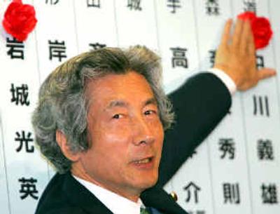 
Prime Minister Junichiro Koizumi puts a rosette on the name of an elected candidate at Liberal Democratic Party headquarters in Tokyo on Sunday. Prime Minister Junichiro Koizumi puts a rosette on the name of an elected candidate at Liberal Democratic Party headquarters in Tokyo on Sunday. 
 (Associated PressAssociated Press / The Spokesman-Review)