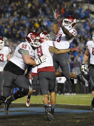 Washington State wide receiver Gabe Marks, center, celebrates his touchdown with offensive lineman Gunnar Eklund, left, and running back Gerard Wicks during the second half of Saturday night’s game against UCLA.
