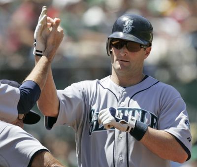 Seattle Mariner Russell Branyan is high-fived in the dugout after his two-run homer off Oakland Athletics starting pitcher Trevor Cahill in the sixth inning in Oakland, Wednesday, May 27, 2009. The Mariners won 6-1. (Associated Press)