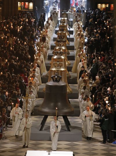 The nine new bronze bells are displayed in Notre Dame cathedral during a ceremony of blessing by Paris Archbishop Andre Vingt-Trois in Paris on Saturday. (Associated Press)