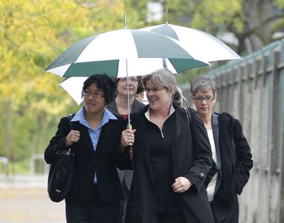Margaret Witt, center, and her partner, Laurie McChesney, right, walk with Sher Kung, left, an attorney with the ACLU, near the federal courthouse in Tacoma, on Monday, Sept. 20, 2010.  (Ted Warren / Associated Press)