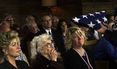
Gladys Dean receives the American flag at the funeral of her husband, Donald L. Dean, at Fairmont Memorial Park on Friday. Two of her daughters, Melody Ellsworth, left, and Pam Snow, sit beside her. 
 (Jed Conklin / The Spokesman-Review)