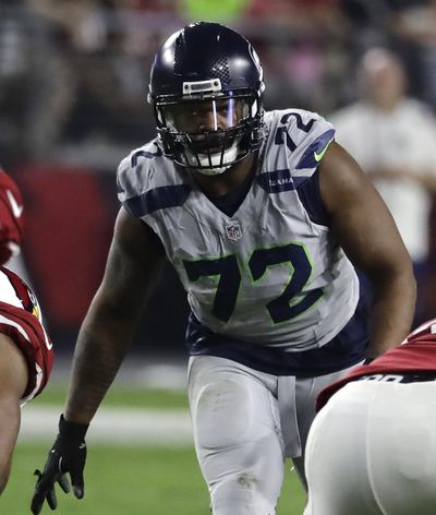 Seattle Seahawks defensive end Michael Bennett may require surgery on his right knee. (RICK SCUTERI / Associated Press)