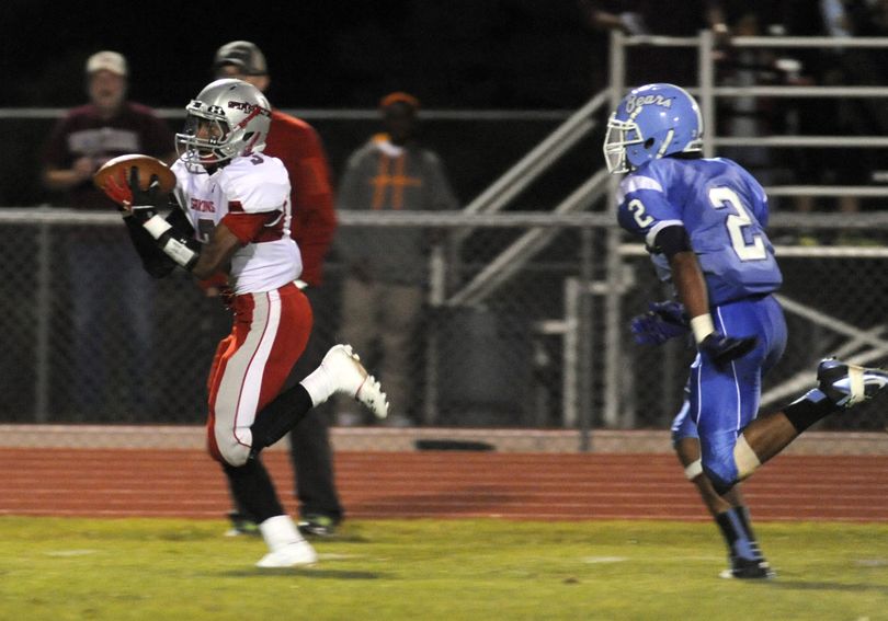 Ferris' Jalen Hicks, left, hauls in a long arcing pass with a few steps ahead of Central Valley J.P. Benson, right, and heads into the end zone for a first-half score, Friday, Sept. 6, 2013. It was 14-14 at half between the GSL powerhouses. (Jesse Tinsley / The Spokesman-Review)