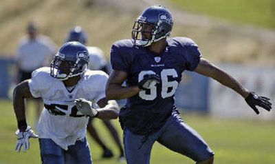 
Seattle linebacker LeRoy Hill covers Seahawks tight end Jerramy Stevens on Tuesday during a training camp drill.
 (Associated Press / The Spokesman-Review)