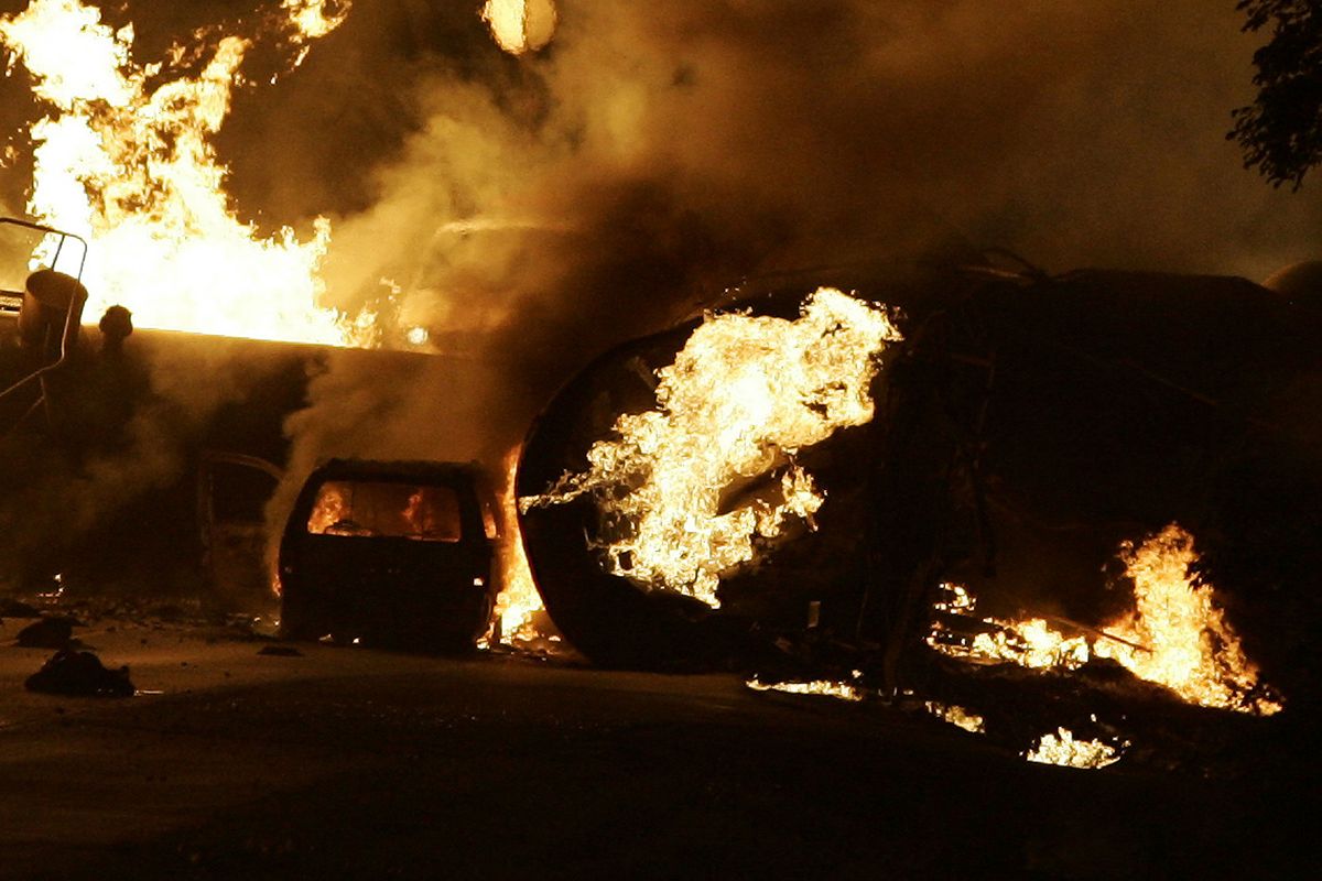 FILE - In this June 19, 2009 file photo, a vehicle burns near a train derailment near Rockford, Ill. Residents were forced to evacuate after the fiery freight train derailment northwest of Chicago. For two decades, one of the nation�s most common types of rail tanker, known as a DOT-111, have been allowed to haul hazardous liquids from coast to coast even though transportation officials were aware of a dangerous design flaw that almost guarantees the car will tear open in an accident. The rail and chemical industries have committed to a safer design for new tankers, but they do not want to modify tens of thousands of existing cars. That�s despite a spike in the number of accidents. (Scott Morgan / Rockford Register Star)