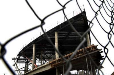 Construction workers install the roof of the new convention center in downtown Spokane Tuesday afternoon. The city and the center are betting that the new structure will bring business to Spokane. 
 (Brian Plonka / The Spokesman-Review)