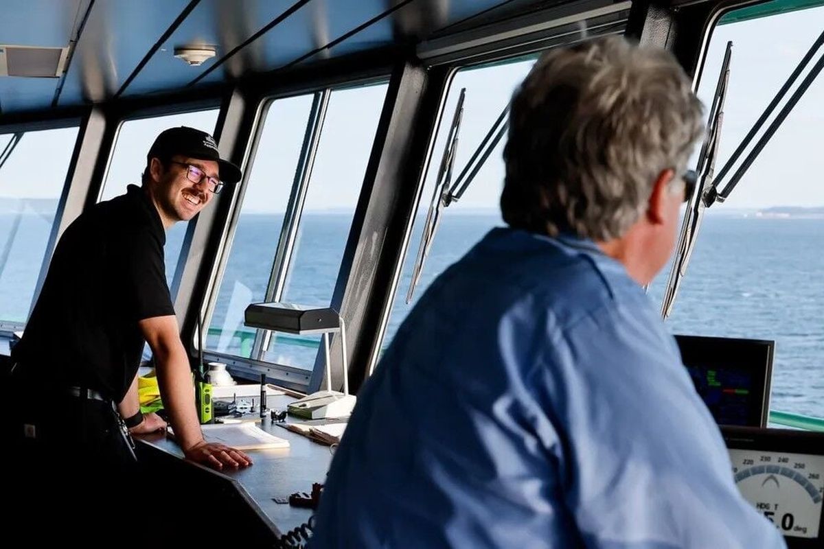 Apprentice Adam Knutsen, left, laughs with Quartermaster Chris Lupton as they make their way to Port Townsend on a recent trip aboard the Washington State Ferry Kennewick. (Seattle Times)