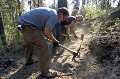 
Dan Webber and Kristin Butcher join 30 other volunteers to construct bike trails Saturday in Camp Sekani, which is owned by the city of Spokane. 
 (Colin Mulvany / The Spokesman-Review)