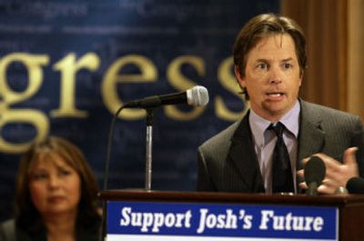 
Actor Michael J. Fox joins Tammy Duckworth, the Democratic candidate for the U.S. House in Illinois' 6th Congressional District, during a rally for stem cell research Tuesday in Wheaton, Ill. 
 (Associated Press / The Spokesman-Review)