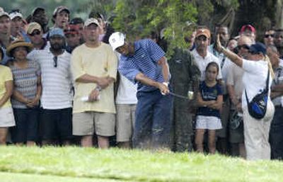 
Tiger Woods' frustrating round Saturday was punctuated with a shot from the rough on the 18th hole. Associated Press
 (Associated Press / The Spokesman-Review)