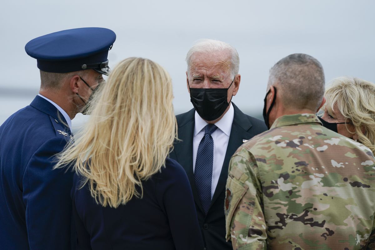 President Joe Biden and Jill Biden are greeted as they arrive at Dover Air Force Base, Del., Sunday, Aug. 29, 2021. Biden embarked on a solemn journey Sunday to honor and mourn the 13 U.S. troops killed in the suicide attack near the Kabul airport as their remains return to U.S. soil from Afghanistan.  (Manuel Balce Ceneta)