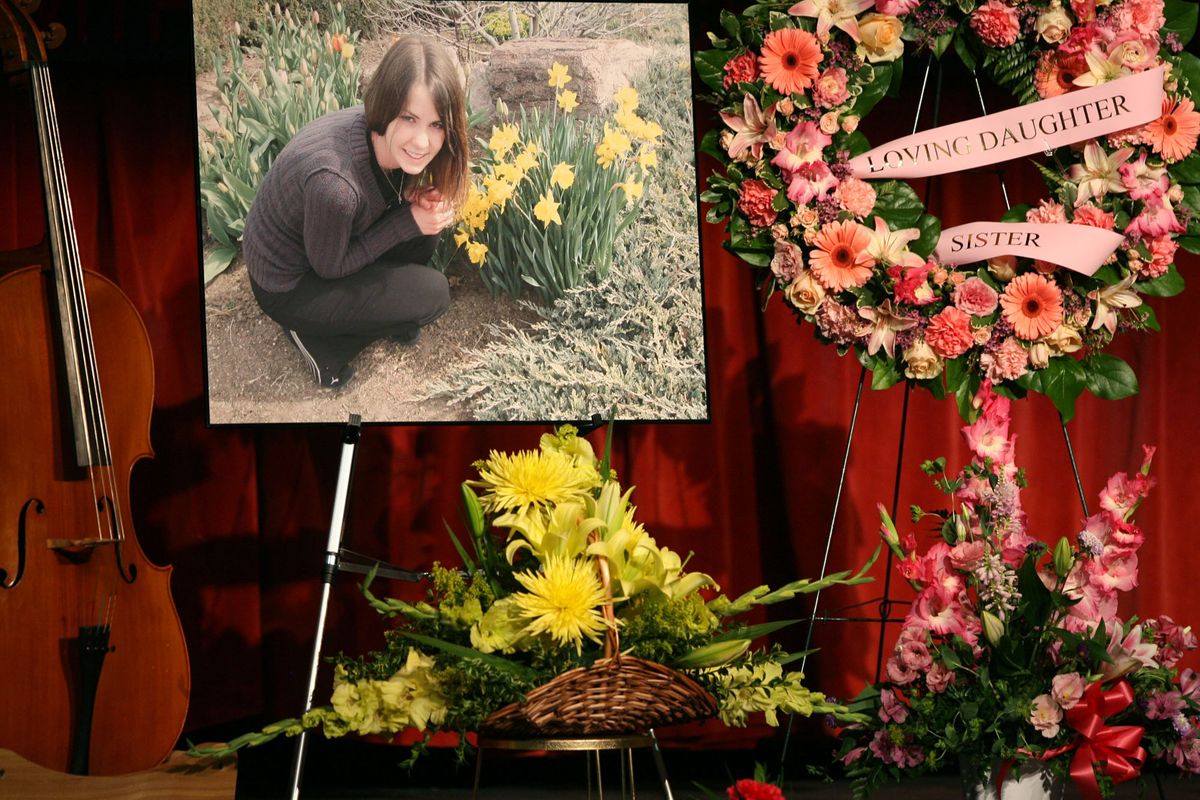 A cello and flowers frame an image of Katy Benoit at her memorial service Tuesday at Boise High School. (Chris Butler / The Idaho Statesman)