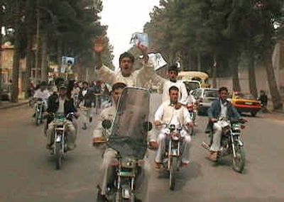 
In this image taken from video, Afghans demonstrate in support of Ismail Khan and against the U.S. presence in the country, in the western city of Herat, Afghanistan, on Saturday. Hundreds of people marched and clashed with police trying to prevent them from reaching the governor's residence. 
 (Associated Press / The Spokesman-Review)