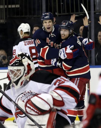 Taylor Pyatt (14) celebrates his goal with Rangers teammate Brad Richards during the second period of a win over the Devils. (Associated Press)