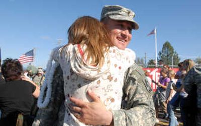 
Seneka Silbert, 11, hugs her father, 1st. Lt. Jan Silbert, as he gets off the bus from Fort Lewis at the Army Reserve Center in Hayden on Wednesday. 
 (Photos by JESSE TINSLEY / The Spokesman-Review)