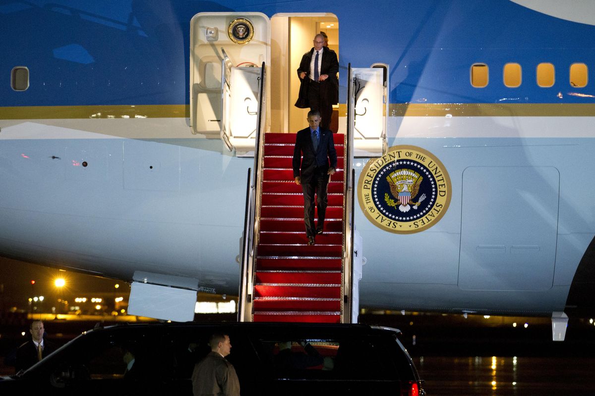 President Barack Obama walks down the stairs from Air Force One upon his arrival at Andrews Air Force Base, Md., Tuesday, Dec. 1, 2015, after returning from the COP21 climate change summit in Paris.