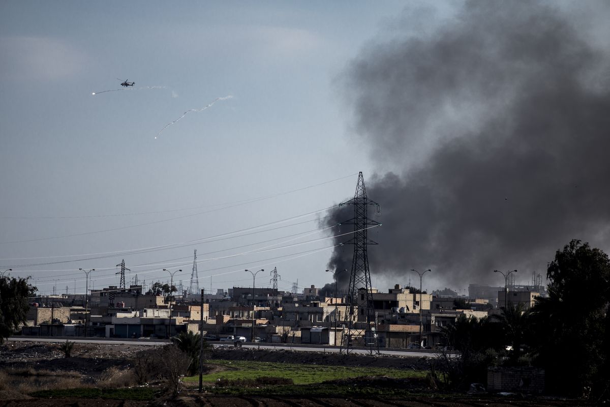 US attack helicopter shoots flares in Hassakeh, northeast Syria, Wednesday, Jan. 26, 2022. Dozens of armed Islamic State militants remained holed up in the last occupied section of a Syrian prison, U.S.-backed Kurdish-led forces said Thursday. The two sides clashed a day after the Syrian Democratic Forces announced they had regained full control of the facility.  (Baderkhan Ahmad)
