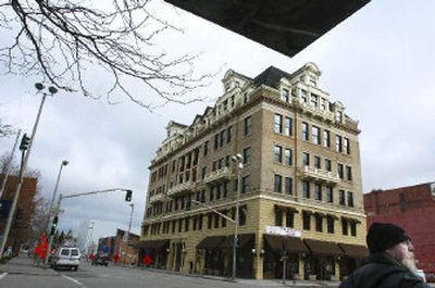 
Leon Graham waits for the light to change at the corner of Washington Street and Riverside Avenue, diagonally across from the Legion Building, which was renovated to restore its historic look. 