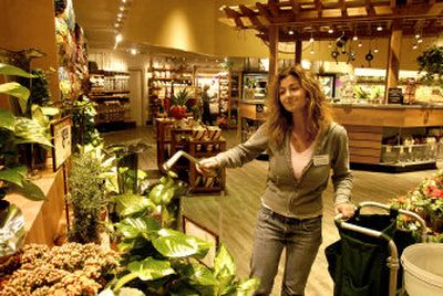 
Floral manager Stephanie Walker waters plants in her expanded department at the Safeway store in Coeur d