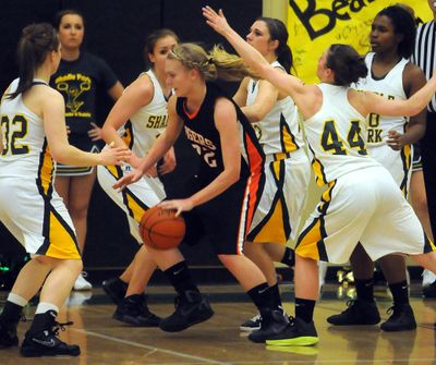 Hayley Hendricksen finds herself in hostile territory during LC’s 60-55 overtime loss at Shadle Park. (Jesse Tinsley)