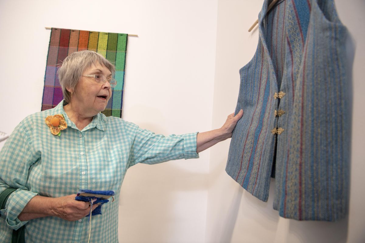 Arlene Klotz, a member of the Spokane Handweavers’ Guild, talks about the wool and silk vest she made on her loom.  Guild members are showing their pieces in the Chase Gallery at Spokane City Hall. (Jesse Tinsley / The Spokesman-Review)