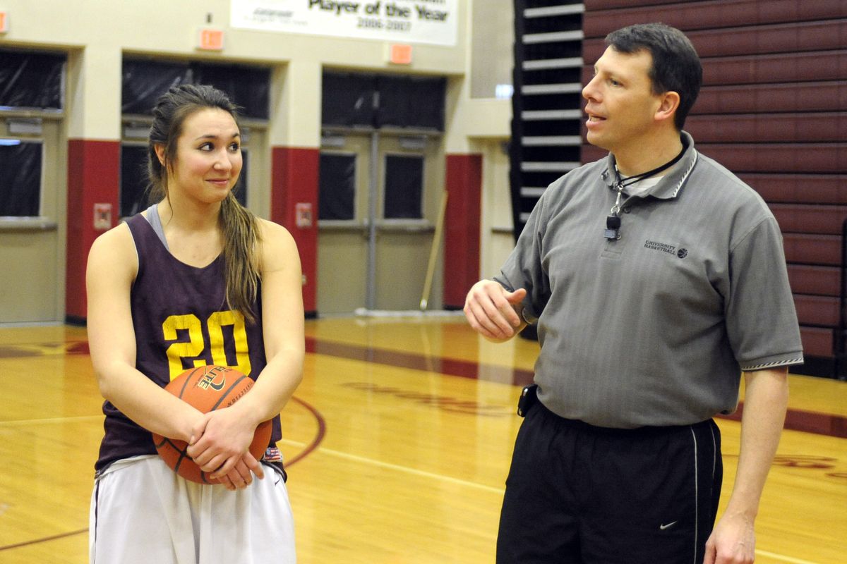 University High School senior Kylie Collins listens to girls basketball coach Mark Stinson during practice on Wednesday. Kylie is a starter on the Titan basketball team and also plays club volleyball and is on the Titan volleyball team. (Jesse Tinsley)