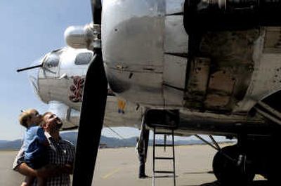 
Mark McWhorter, of Hayden, and his son Cade, 2, check out the B-17 Flying Fortress at Coeur d'Alene Airport in Hayden on Monday. 
 (Kathy Plonka / The Spokesman-Review)
