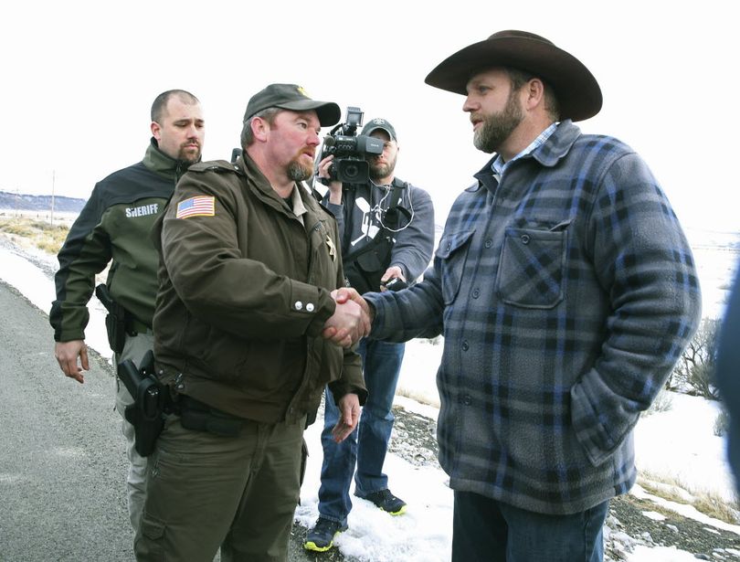 Harney County Sheriff Dave Ward meets with Ammon Bundy at a remote location outside the Malheur National Wildlife Refuge on Thursday, Jan. 7, near Burns, Ore. Early in the aborted siege, Ward and two other Oregon sheriffs met with the now-jailed leader of an armed group occupying a federal wildlife refuge and asked them to leave, after residents made it clear they wanted them to go home. (Beth Nakamura/The Oregonian via AP)