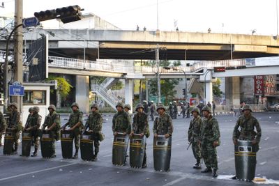 Thai soldiers take up a position in Bangkok, Thailand, early today. Thai combat troops are in position around the last stronghold of anti-government demonstrators following a day of street battles across the capital that left two dead and more than 100 injured.  (Associated Press / The Spokesman-Review)