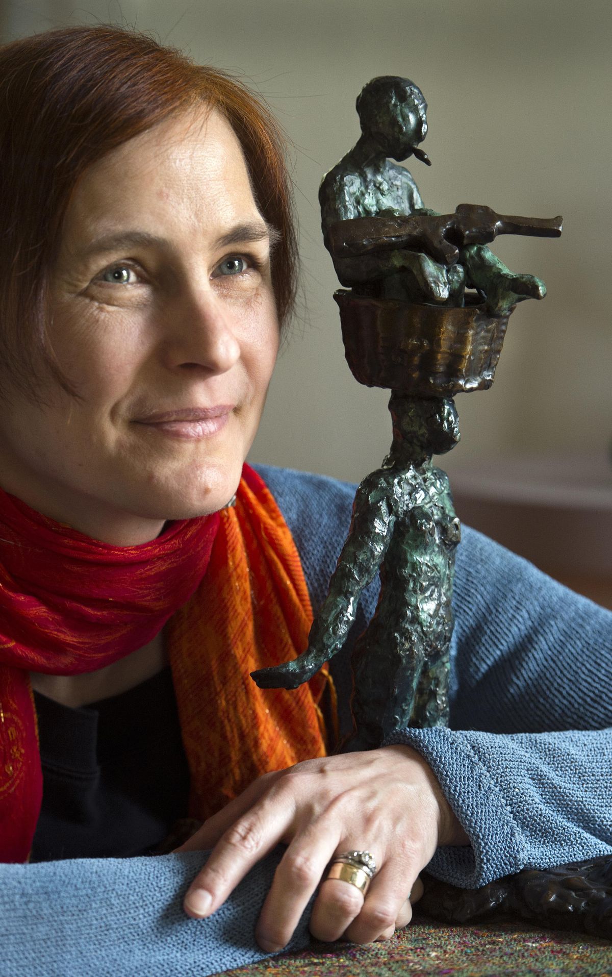 Spokane artist Ildikó Kalapács created the bronze “Bearing” sculpture, depicting a woman carrying a man holding a military-style rifle and sitting in a basket on her head. The piece celebrates the strength of the human spirit as it carries the burdens of the physical and emotional aftermath of war. (Dan Pelle / The Spokesman-Review)