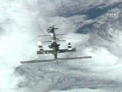 
Earth looms behind the international space station after the space shuttle Discovery left it Saturday. 
 (Associated Press / The Spokesman-Review)